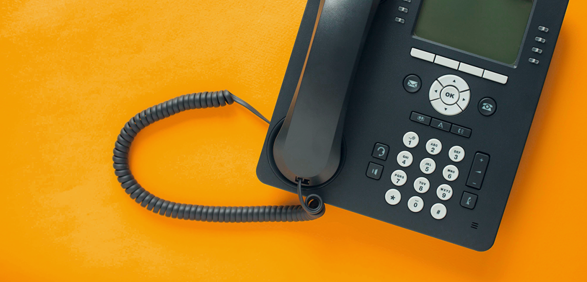 Image of black telephone on orange background