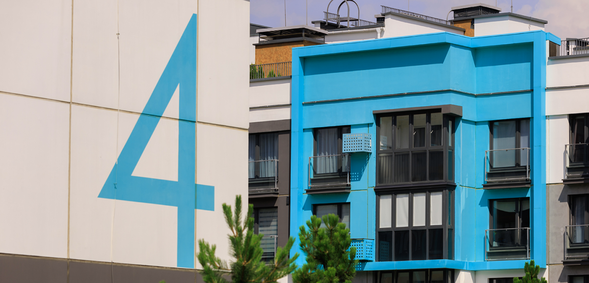 A close-up shot of a number four on the side of an office building.
